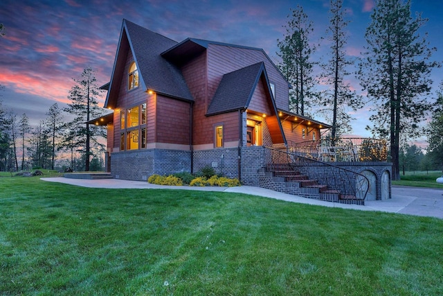 16615 W Stoughton Rd, Cheney, WA 99004 - property exterior at dusk featuring stairs, a lawn, and a shingled roof