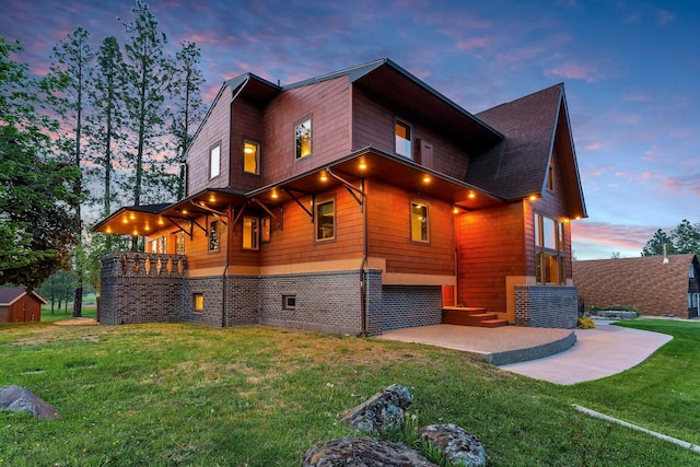 16615 W Stoughton Rd, Cheney, WA 99004 - view of property exterior with a patio, a lawn, a balcony, and a storage shed