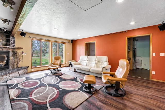 16615 W Stoughton Rd, Cheney, WA 99004 - living room featuring wood finished floors, baseboards, a large fireplace, a textured ceiling, and recessed lighting