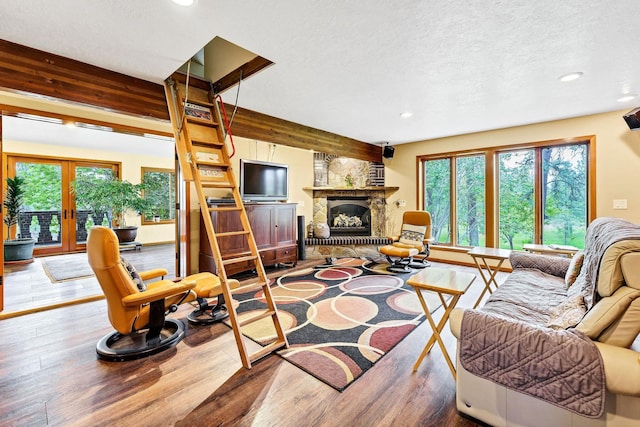 16615 W Stoughton Rd, Cheney, WA 99004 - living area featuring wood finished floors, recessed lighting, french doors, a fireplace, and a textured ceiling
