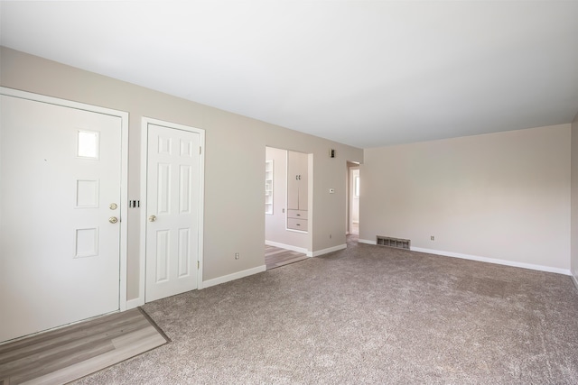 1715 N Jefferson St Unit 1717, Spokane, WA 99205 - unfurnished living room featuring carpet flooring and baseboards