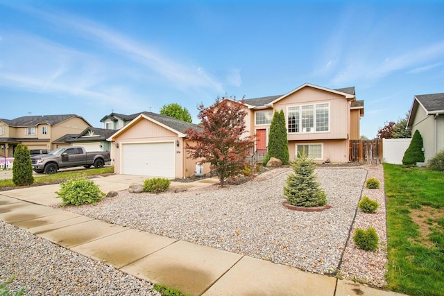 1104 S Comax Ct, Spokane, WA 99224 - view of front of house featuring fence, concrete driveway, and a garage