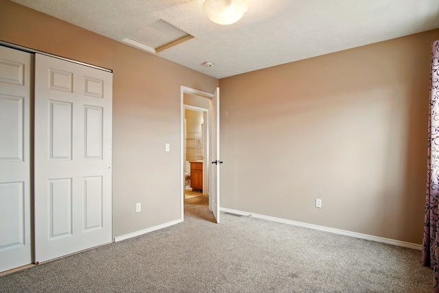 1104 S Comax Ct, Spokane, WA 99224 - unfurnished bedroom featuring carpet flooring, attic access, baseboards, a closet, and a textured ceiling