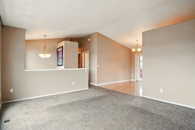 1104 S Comax Ct, Spokane, WA 99224 - spare room with carpet floors, a chandelier, baseboards, and lofted ceiling