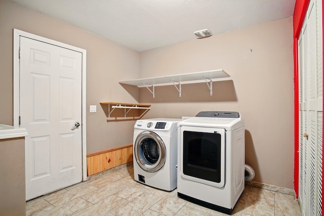 1104 S Comax Ct, Spokane, WA 99224 - washroom featuring independent washer and dryer, baseboards, and light marble finish flooring