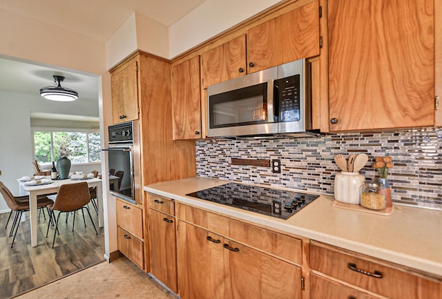 2033 S Rebecca St, Spokane, WA 99223 - kitchen featuring wall oven, stainless steel microwave, black electric stovetop, light countertops, and backsplash
