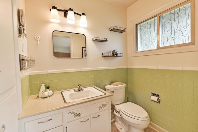 2033 S Rebecca St, Spokane, WA 99223 - bathroom with tile walls, toilet, wainscoting, and vanity