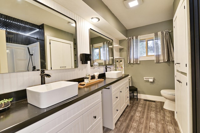 2033 S Rebecca St, Spokane, WA 99223 - full bathroom featuring baseboards, wood finished floors, toilet, and double vanity