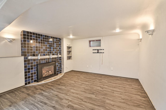 2033 S Rebecca St, Spokane, WA 99223 - unfurnished living room with wood finished floors, a fireplace, and baseboards