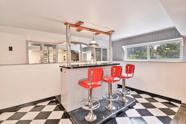 2033 S Rebecca St, Spokane, WA 99223 - kitchen featuring tile patterned floors, a breakfast bar, and dark countertops