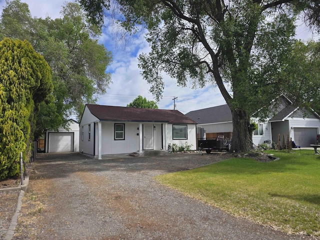 3019 E Augusta Ave, Spokane, WA 99207 - single story home with driveway, an outdoor structure, a front yard, and a detached garage