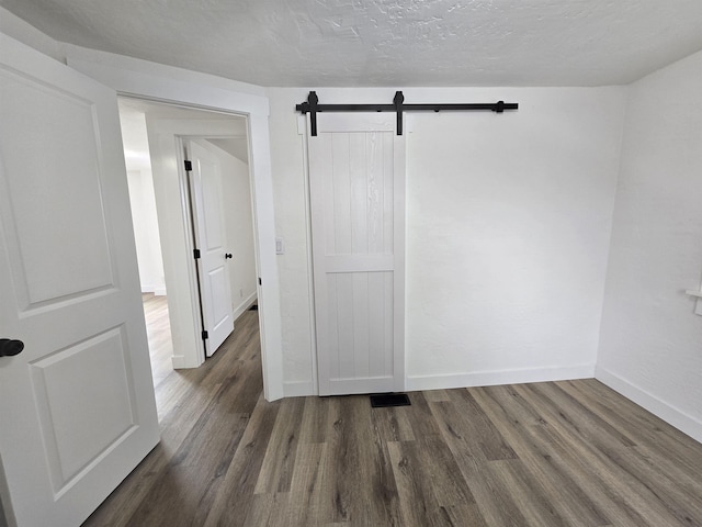 3019 E Augusta Ave, Spokane, WA 99207 - empty room with wood finished floors, baseboards, and a barn door