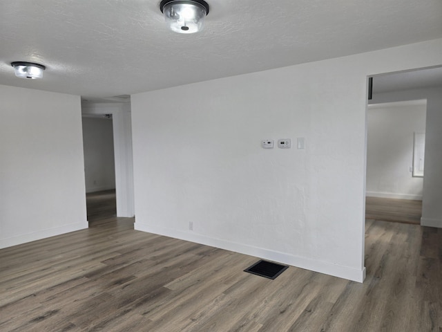3019 E Augusta Ave, Spokane, WA 99207 - empty room with wood finished floors, baseboards, and a textured ceiling