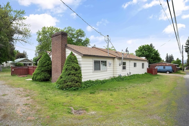 view of side of home featuring a chimney