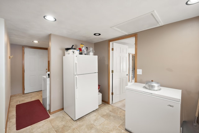 kitchen with freestanding refrigerator, white refrigerator, recessed lighting, light countertops, and baseboards