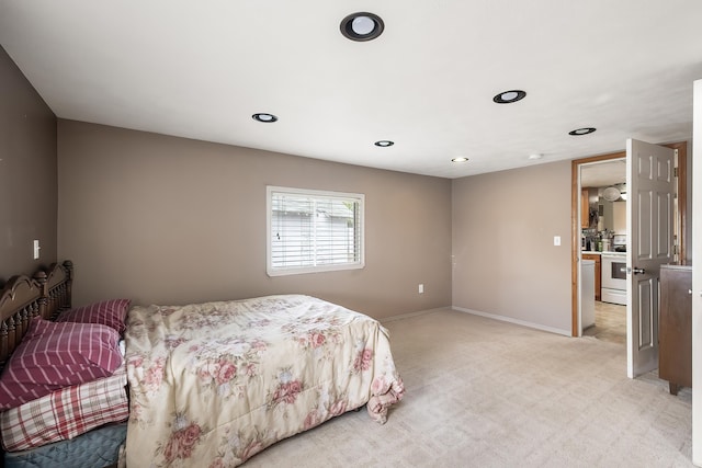 bedroom with light colored carpet, recessed lighting, and baseboards