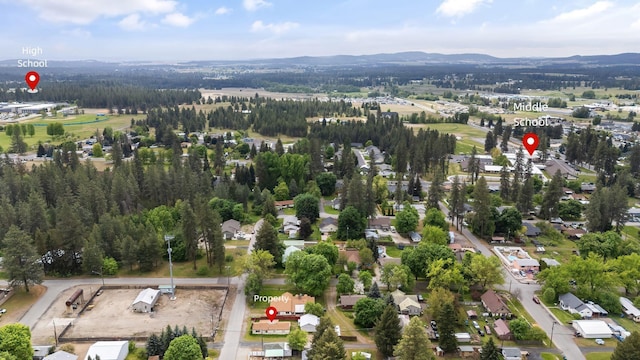 aerial view of property's location featuring a mountain backdrop and nearby suburban area