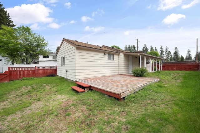 rear view of house with a wooden deck