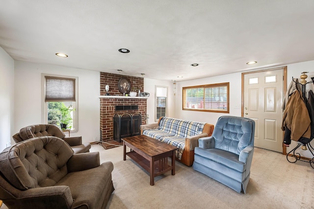 living area with plenty of natural light, light colored carpet, recessed lighting, and a fireplace