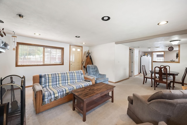 living area with baseboards, light colored carpet, recessed lighting, and healthy amount of natural light