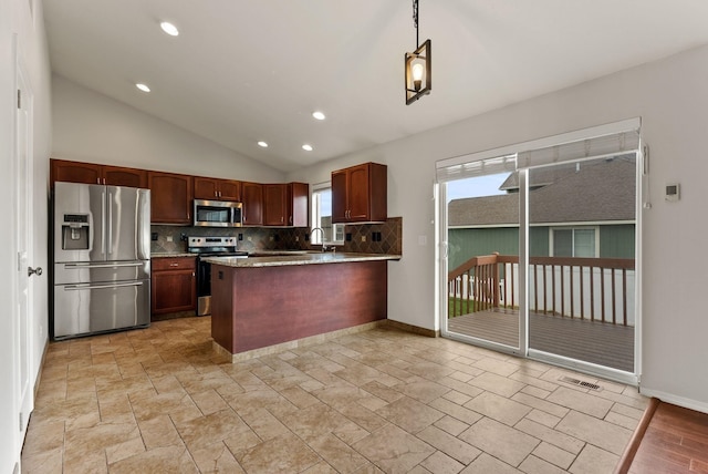 kitchen featuring stainless steel appliances, decorative backsplash, lofted ceiling, a peninsula, and baseboards