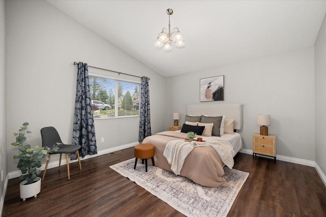 bedroom featuring a chandelier, baseboards, vaulted ceiling, and wood finished floors