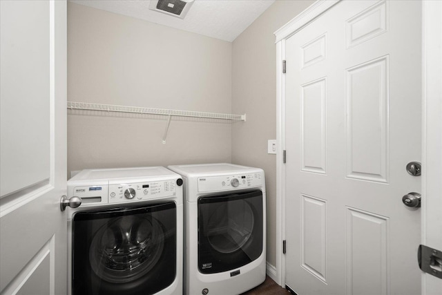 washroom featuring washing machine and clothes dryer