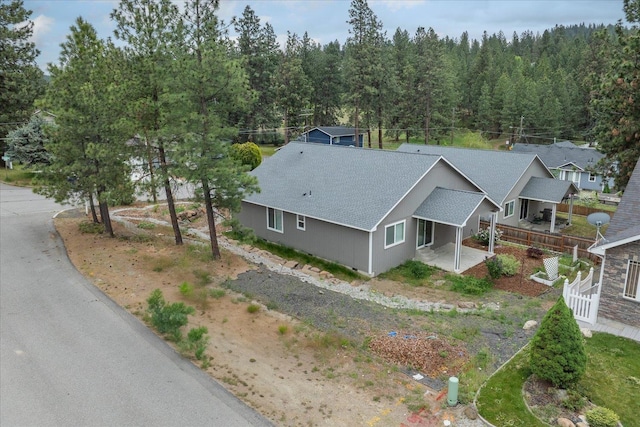 aerial view of property and surrounding area with a heavily wooded area