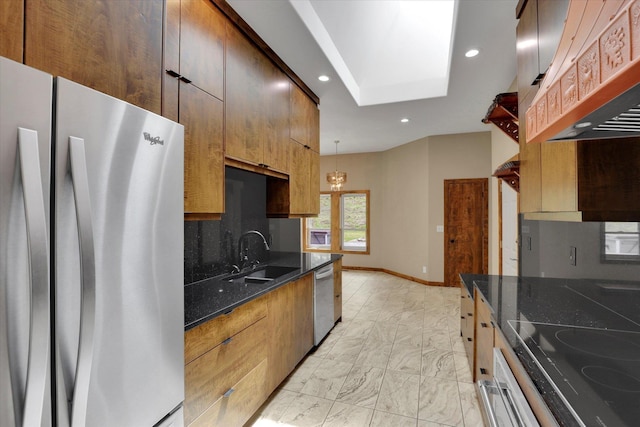 30915 N Chipmunk Rd, Chattaroy, WA 99003 - kitchen with appliances with stainless steel finishes, a sink, ventilation hood, light marble finish floors, and dark stone countertops