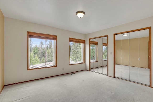 30915 N Chipmunk Rd, Chattaroy, WA 99003 - unfurnished bedroom with two closets, carpet, and baseboards