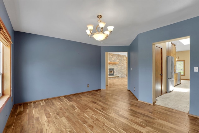 30915 N Chipmunk Rd, Chattaroy, WA 99003 - unfurnished room with a chandelier and light wood-style floors