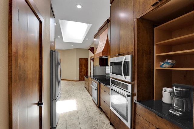 30915 N Chipmunk Rd, Chattaroy, WA 99003 - kitchen featuring stainless steel appliances, dark countertops, light marble finish flooring, a skylight, and recessed lighting