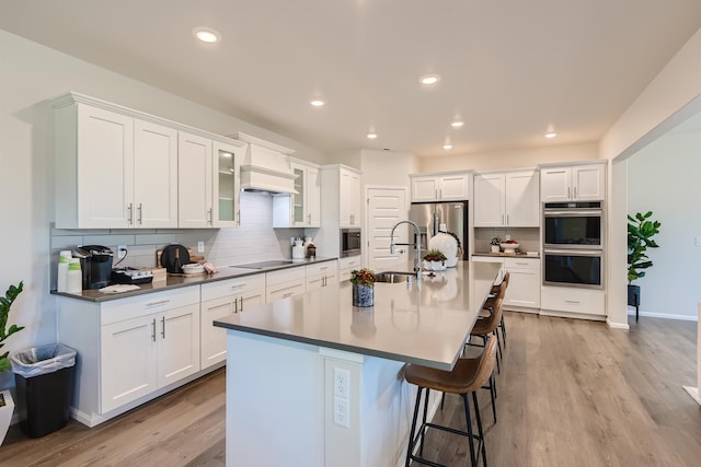 3029 S Coulter Ln, Spokane Valley, WA 99037 - kitchen with a sink, appliances with stainless steel finishes, premium range hood, decorative backsplash, and white cabinetry