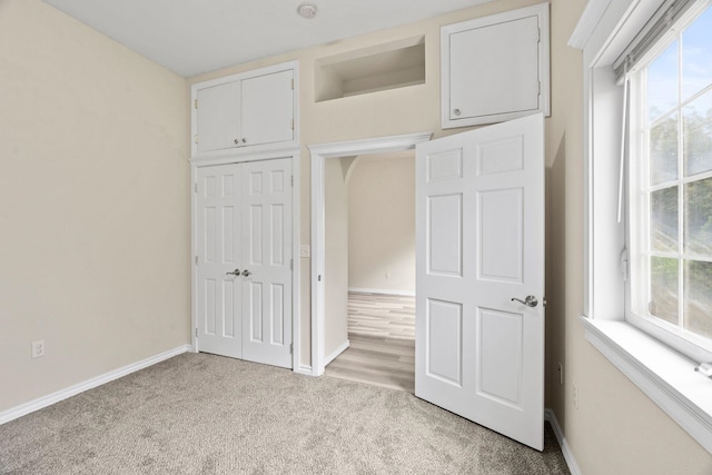 2212 W Gardner Ave, Spokane, WA 99201 - unfurnished bedroom featuring light colored carpet, a closet, and baseboards
