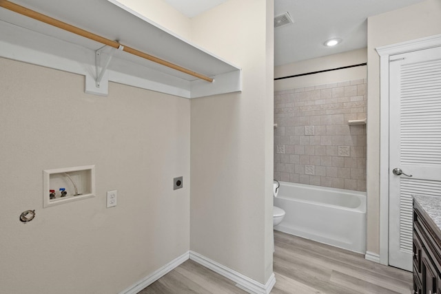 2212 W Gardner Ave, Spokane, WA 99201 - washroom with electric dryer hookup, washer hookup, light wood-style floors, and baseboards