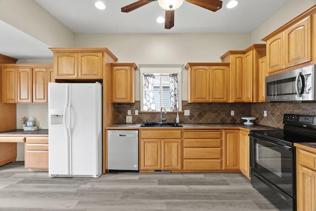 2212 W Gardner Ave, Spokane, WA 99201 - kitchen featuring stainless steel microwave, white fridge with ice dispenser, dishwashing machine, black / electric stove, and a sink