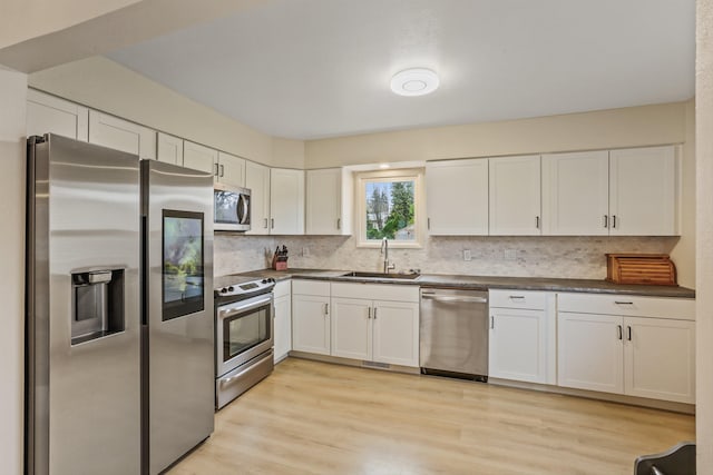 13513 E 12th Ave, Spokane Valley, WA 99216 - kitchen featuring appliances with stainless steel finishes, a sink, dark countertops, and decorative backsplash