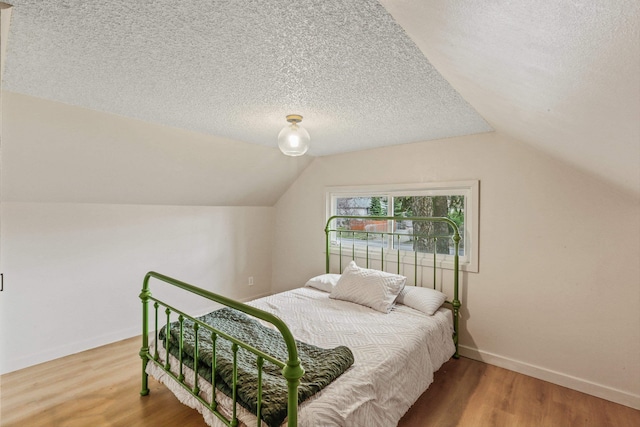13513 E 12th Ave, Spokane Valley, WA 99216 - bedroom featuring lofted ceiling, wood finished floors, a textured ceiling, and baseboards