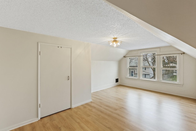 13513 E 12th Ave, Spokane Valley, WA 99216 - bonus room with light wood-style flooring, lofted ceiling, a textured ceiling, and baseboards