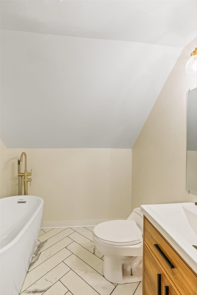 13513 E 12th Ave, Spokane Valley, WA 99216 - bathroom featuring vaulted ceiling, vanity, a soaking tub, marble look tiles, and toilet