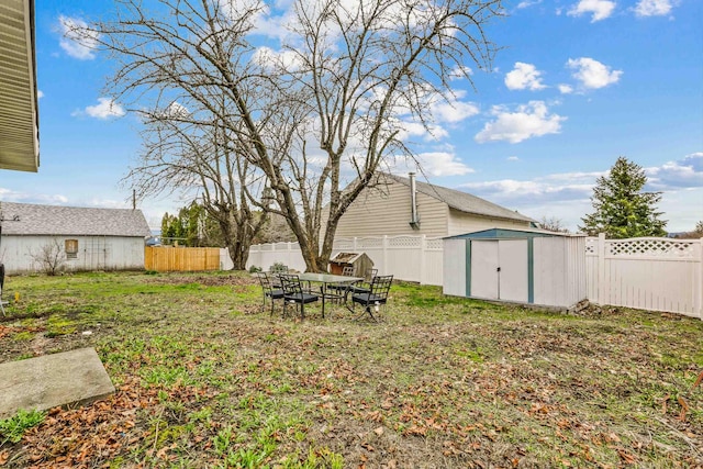 13513 E 12th Ave, Spokane Valley, WA 99216 - view of yard featuring a shed, an outbuilding, and outdoor dining area