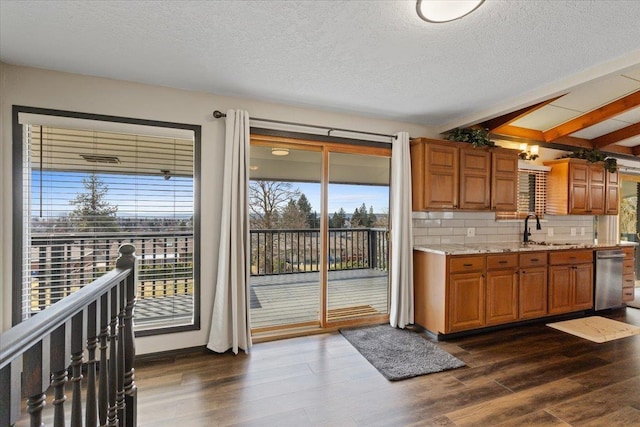 2311 W Wedgewood Ave, Spokane, WA 99208 - kitchen featuring a sink, stainless steel dishwasher, tasteful backsplash, plenty of natural light, and a textured ceiling