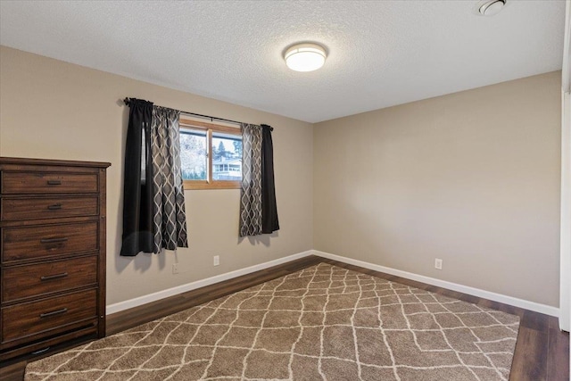 2311 W Wedgewood Ave, Spokane, WA 99208 - unfurnished room featuring wood finished floors, baseboards, and a textured ceiling