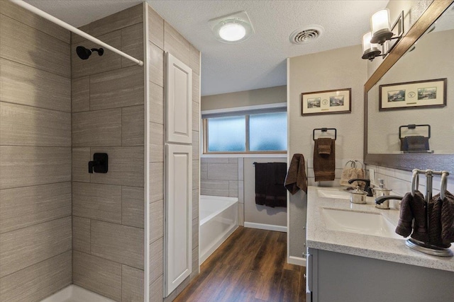 2311 W Wedgewood Ave, Spokane, WA 99208 - full bathroom with wood finished floors, a shower, a bathtub, and double vanity