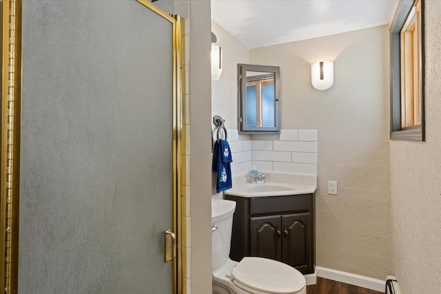 2311 W Wedgewood Ave, Spokane, WA 99208 - bathroom with a stall shower, toilet, wood finished floors, vanity, and backsplash