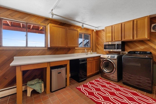 2311 W Wedgewood Ave, Spokane, WA 99208 - laundry area with track lighting, healthy amount of natural light, tile patterned flooring, washer and clothes dryer, and wooden walls