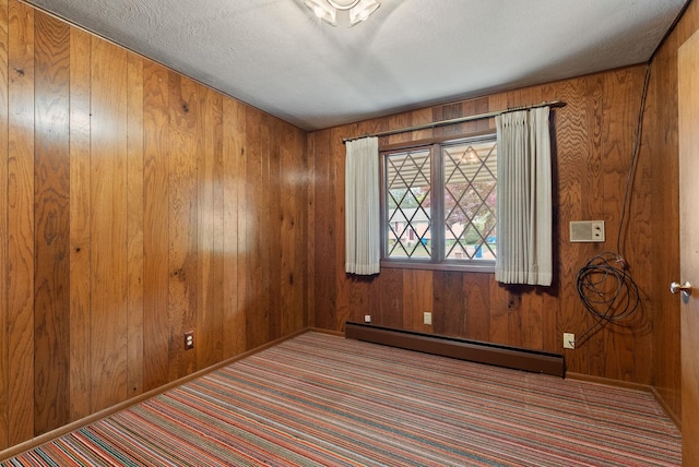 1610 E 35th Ave, Spokane, WA 99203 - empty room with a baseboard heating unit, carpet floors, and wooden walls