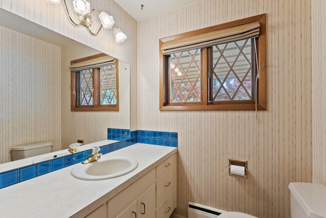 1610 E 35th Ave, Spokane, WA 99203 - half bathroom with toilet, wallpapered walls, a baseboard heating unit, vanity, and a chandelier