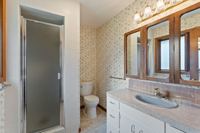 1610 E 35th Ave, Spokane, WA 99203 - full bath with a shower stall, wallpapered walls, vanity, toilet, and tile patterned flooring