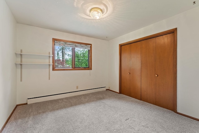 1610 E 35th Ave, Spokane, WA 99203 - unfurnished bedroom with a baseboard radiator, carpet floors, a closet, and baseboards